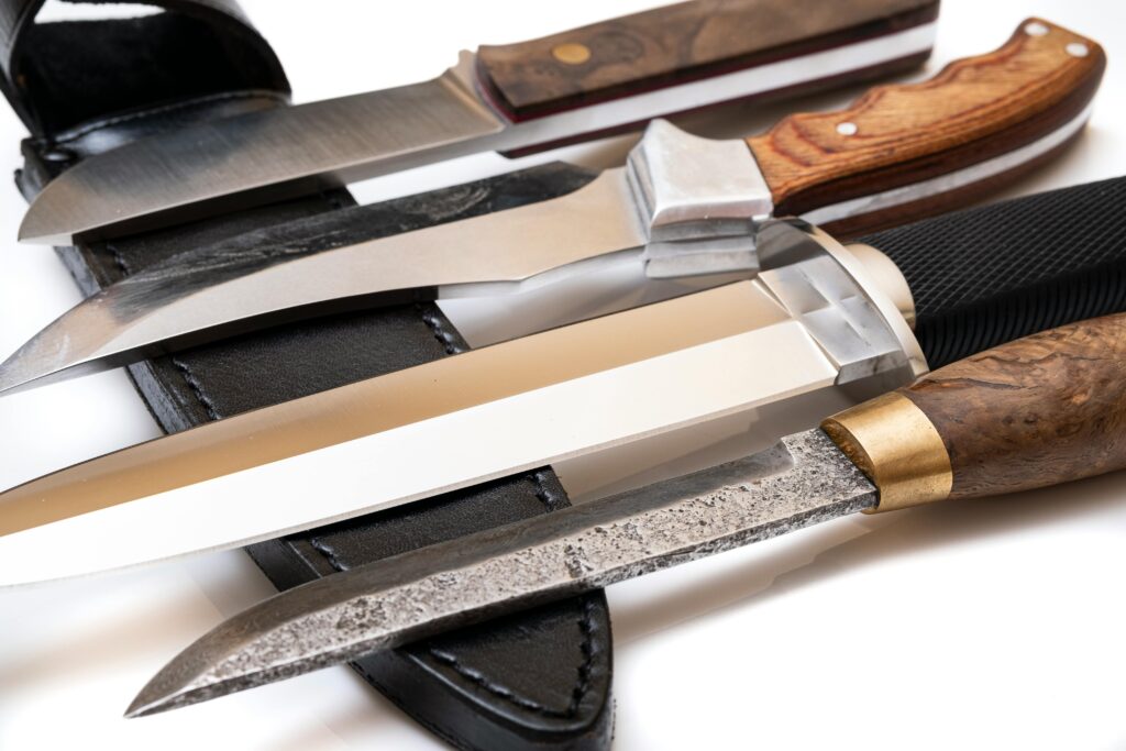 Various EDC knives showcasing different blade steels